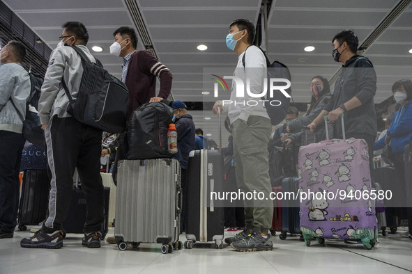 Travelers wearing face masks waiting for the gates to open at the Lok Ma Chau Border Crossing on January 8, 2023 in Hong Kong, China. Hong K...