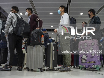 Travelers wearing face masks waiting for the gates to open at the Lok Ma Chau Border Crossing on January 8, 2023 in Hong Kong, China. Hong K...