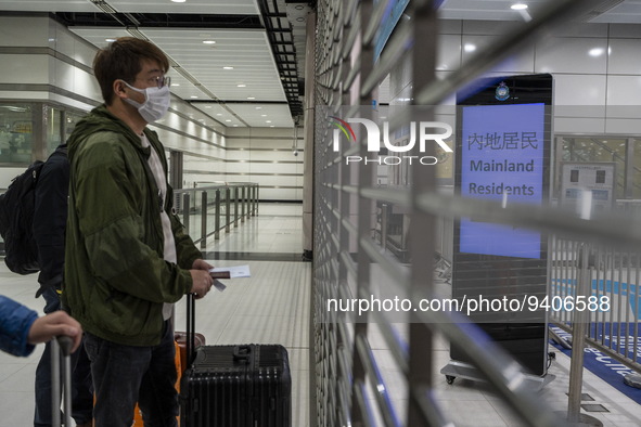 A man wearing face masks waiting for the gates to open at the Lok Ma Chau Border Crossing on January 8, 2023 in Hong Kong, China. Hong Kong...