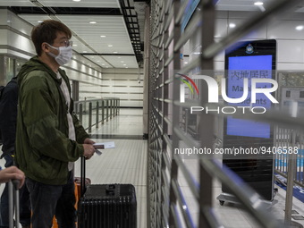 A man wearing face masks waiting for the gates to open at the Lok Ma Chau Border Crossing on January 8, 2023 in Hong Kong, China. Hong Kong...