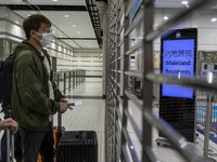 A man wearing face masks waiting for the gates to open at the Lok Ma Chau Border Crossing on January 8, 2023 in Hong Kong, China. Hong Kong...