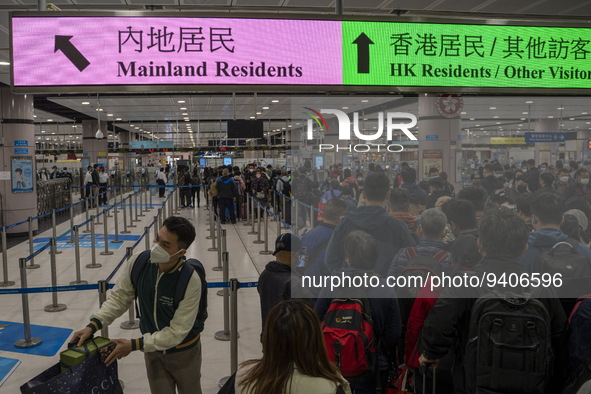 Travelers wearing face mask waiting in line to cross the border at the Lok Ma Chau Border Crossing on January 8, 2023 in Hong Kong, China. H...