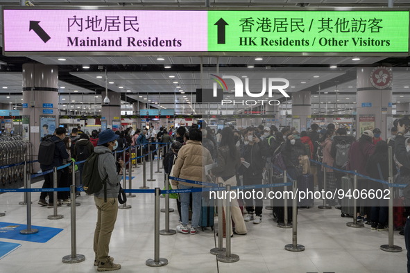 Travelers wearing face mask waiting in line to cross the border at the Lok Ma Chau Border Crossing on January 8, 2023 in Hong Kong, China. H...