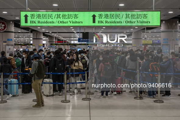 Travelers wearing face mask waiting in line to cross the border at the Lok Ma Chau Border Crossing on January 8, 2023 in Hong Kong, China. H...