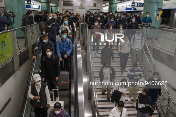 Travelers wearing face masks arriving at Lok Ma Chau Station on January 8, 2023 in Hong Kong, China. Hong Kong today resumes quarantine free...