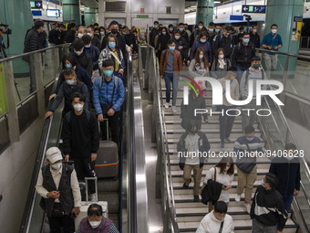 Travelers wearing face masks arriving at Lok Ma Chau Station on January 8, 2023 in Hong Kong, China. Hong Kong today resumes quarantine free...