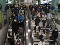 Travelers wearing face masks arriving at Lok Ma Chau Station on January 8, 2023 in Hong Kong, China. Hong Kong today resumes quarantine free...