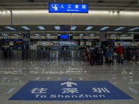 A sign on the ground pointing to Shenzhen at the immigration checkpoint in Futian Port on January 8, 2023 in Shenzhen, China. Hong Kong toda...