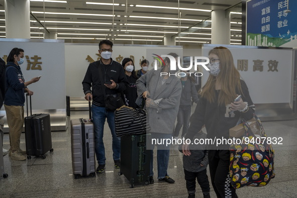 Travelers wearing Face Masks with suitcases arriving at Futian Port on January 8, 2023 in Shenzhen, China. Hong Kong today resumes quarantin...