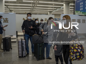 Travelers wearing Face Masks with suitcases arriving at Futian Port on January 8, 2023 in Shenzhen, China. Hong Kong today resumes quarantin...