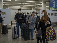 Travelers wearing Face Masks with suitcases arriving at Futian Port on January 8, 2023 in Shenzhen, China. Hong Kong today resumes quarantin...