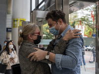 A man hugs his mother as they meet for the first time in 3 years outside Futian Port on January 8, 2023 in Shenzhen, China. Hong Kong today...