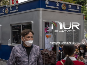 A worker dress in a rabbit costume standing inside a police post outside Futian Port on January 8, 2023 in Shenzhen, China. Hong Kong today...