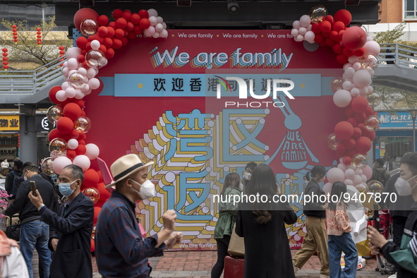 People walks pass a banner welcoming Visitors from Hong Kong outside Futian Port on January 8, 2023 in Shenzhen, China. Hong Kong today resu...