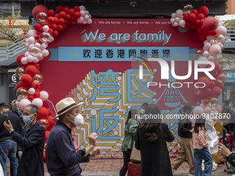 People walks pass a banner welcoming Visitors from Hong Kong outside Futian Port on January 8, 2023 in Shenzhen, China. Hong Kong today resu...