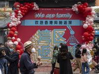 People walks pass a banner welcoming Visitors from Hong Kong outside Futian Port on January 8, 2023 in Shenzhen, China. Hong Kong today resu...