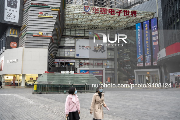 People wearing face masks walking in Huaqiangbei, a popular place to buy electronic goods on January 8, 2023 in Shenzhen, China. China today...