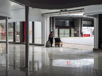 A delivery worker waiting at an entrance of a shopping center in Huaqiangbei, a popular place to buy electronic goods on January 8, 2023 in...