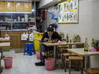 A man eating inside a restaurant on January 8, 2023 in Shenzhen, China. China today lifts its requirement for inbound travelers to undergo a...