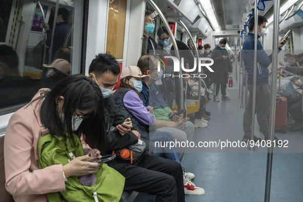 People wearing face masks riding on the metro on January 8, 2023 in Shenzhen, China. China today lifts its requirement for inbound travelers...