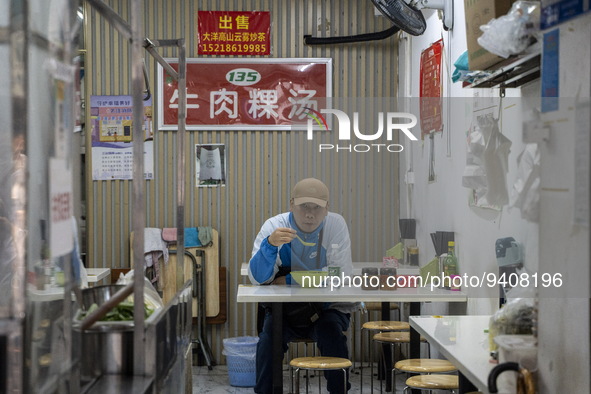 A man eating inside a restaurant on January 8, 2023 in Shenzhen, China. China today lifts its requirement for inbound travelers to undergo a...