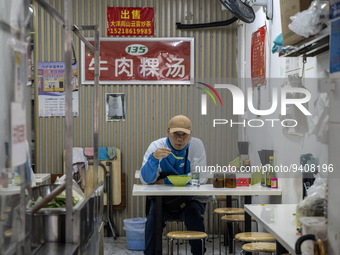 A man eating inside a restaurant on January 8, 2023 in Shenzhen, China. China today lifts its requirement for inbound travelers to undergo a...