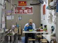 A man eating inside a restaurant on January 8, 2023 in Shenzhen, China. China today lifts its requirement for inbound travelers to undergo a...