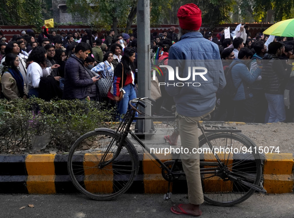 A man watches as participants and supporters of LGBTQ community take part in the annual Delhi Queer Pride March, an event promoting lesbian,...