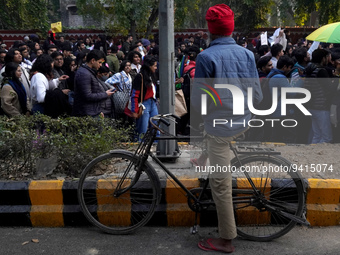 A man watches as participants and supporters of LGBTQ community take part in the annual Delhi Queer Pride March, an event promoting lesbian,...