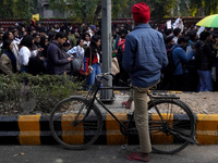 A man watches as participants and supporters of LGBTQ community take part in the annual Delhi Queer Pride March, an event promoting lesbian,...