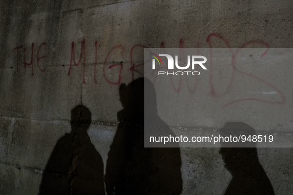 Refugees and migrants spend the night in a camp outside a processing center in Moria and Karatepe villages on the on the northeastern Greek...