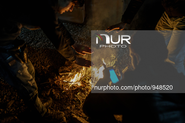 Refugees and migrants spend the night in a camp outside a processing center in Moria and Karatepe villages on the on the northeastern Greek...