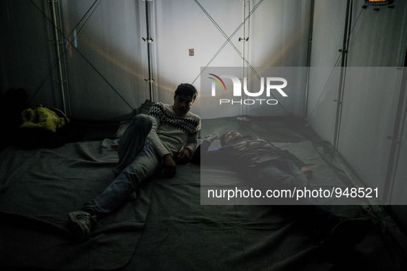 Refugees and migrants spend the night in a camp outside a processing center in Moria and Karatepe villages on the on the northeastern Greek...