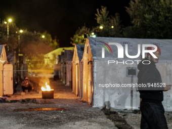 Refugees and migrants spend the night in a camp outside a processing center in Moria and Karatepe villages on the on the northeastern Greek...
