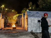 Refugees and migrants spend the night in a camp outside a processing center in Moria and Karatepe villages on the on the northeastern Greek...