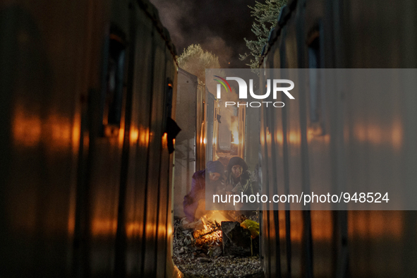 Refugees and migrants spend the night in a camp outside a processing center in Moria and Karatepe villages on the on the northeastern Greek...