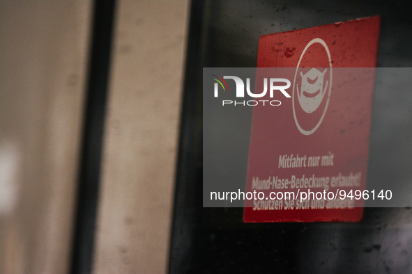 

A sign requiring masks is seen on a Deutsche Bahn ICE high-speed train at Cologne Central Station in Cologne, Germany on January 25, 2021,...