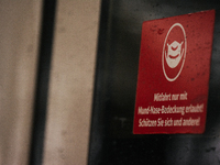 

A sign requiring masks is seen on a Deutsche Bahn ICE high-speed train at Cologne Central Station in Cologne, Germany on January 25, 2021,...