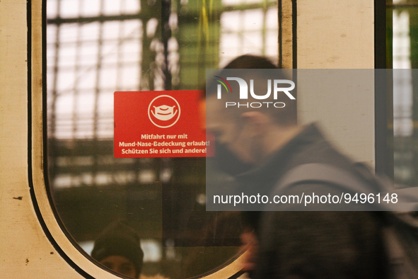 

A sign requiring masks is seen on a Deutsche Bahn ICE high-speed train at Cologne Central Station in Cologne, Germany on January 25, 2021,...