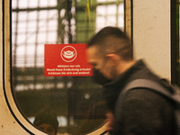 

A sign requiring masks is seen on a Deutsche Bahn ICE high-speed train at Cologne Central Station in Cologne, Germany on January 25, 2021,...