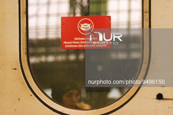 

A sign requiring masks is seen on a Deutsche Bahn ICE high-speed train at Cologne Central Station in Cologne, Germany on January 25, 2021,...