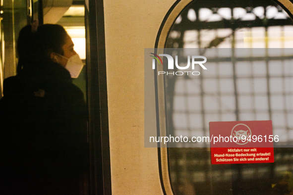 

A sign requiring masks is seen on a Deutsche Bahn ICE high-speed train at Cologne Central Station in Cologne, Germany on January 25, 2021,...