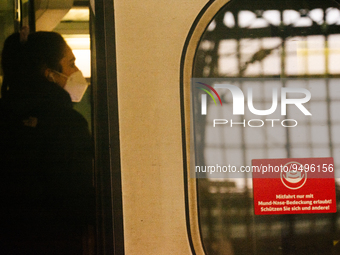 

A sign requiring masks is seen on a Deutsche Bahn ICE high-speed train at Cologne Central Station in Cologne, Germany on January 25, 2021,...