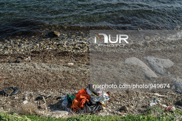 A women holds her child on a beach near to the town of Mytilene after crossing a part of the Aegean sea on a dinghy, with other refugees and...