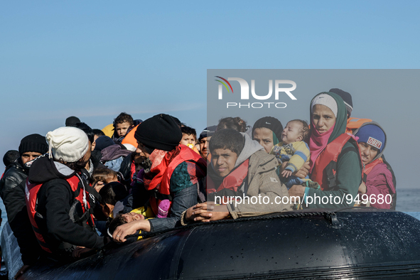 Refugees and migrants arrive on a dingy from the Turkish coast to the northeastern Greek island of Lesbos Dec. 8, 2015. 