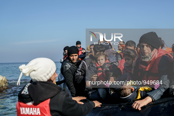 Refugees and migrants arrive on a dingy from the Turkish coast to the northeastern Greek island of Lesbos Dec. 8, 2015. 