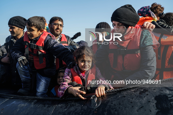 Refugees and migrants arrive on a dingy from the Turkish coast to the northeastern Greek island of Lesbos Dec. 8, 2015. 