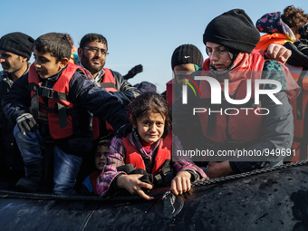 Refugees and migrants arrive on a dingy from the Turkish coast to the northeastern Greek island of Lesbos Dec. 8, 2015. (