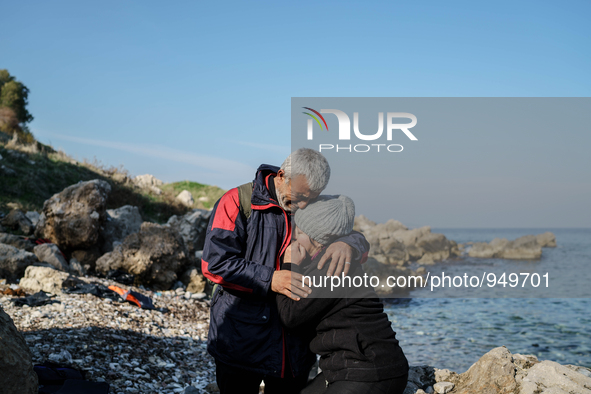 Husband and wife hug each other as a boy cries after their arrival from the Turkish coast to the Greek island of Lesbos Dec. 8, 2015.  