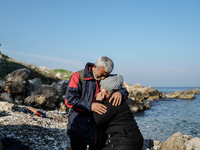Husband and wife hug each other as a boy cries after their arrival from the Turkish coast to the Greek island of Lesbos Dec. 8, 2015.  (
